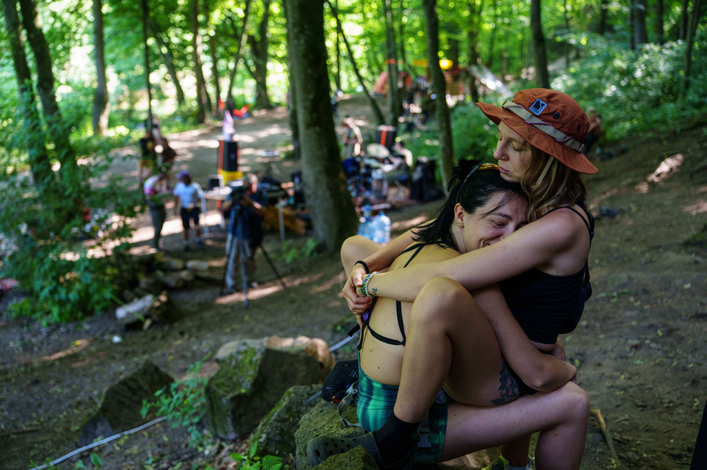 Women rest after climbing during the Stoned Climbers festival near Denyshi, Zhytomyr region, Ukraine, Saturday, June 27, 2026. (AP Photo/Evgeniy Maloletka)
