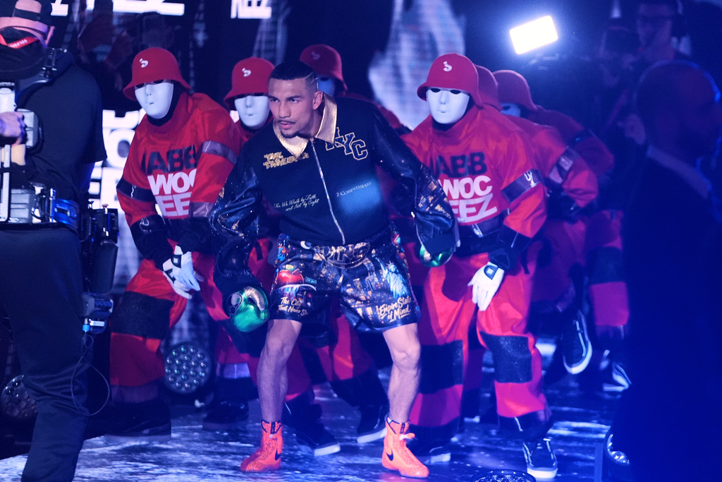 CORRECTS THE NAME TO SHAKUR, NOT SHADUR - Teofimo Lopez walks toward the ring with the The Jabbawockeez for a super lightweight title boxing match against Shakur Stevenson Sunday, Feb. 1, 2026, in New York. (AP Photo/Frank Franklin II)