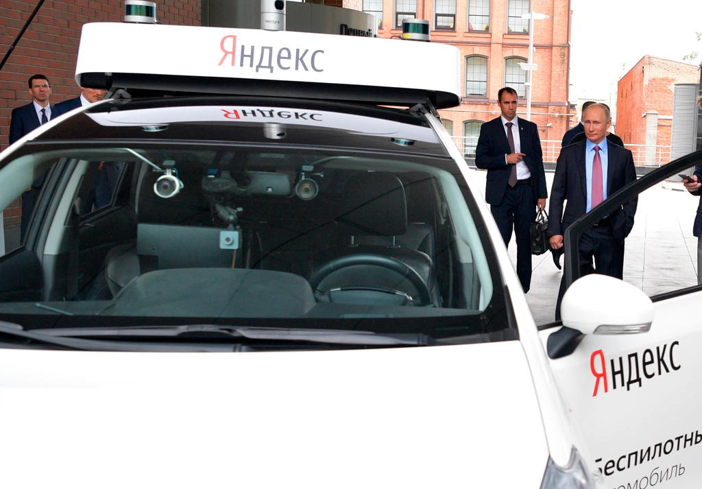 FILE - Russian President Vladimir Putin, right, examines a prototype of a driverless vehicle during a visit to the headquarters of tech giant Yandex in Moscow, Russia, on Sept. 21, 2017. (Alexei Druzhinin, Sputnik, Kremlin Pool Photo via AP, File)