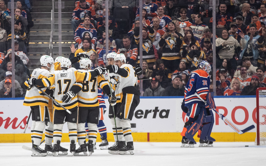 Pittsburgh Penguins players, left, celebrate after a goal as Edmonton Oilers goalie Tristan Jarry (35) looks on during second-period NHL hockey game action in Edmonton, Alberta, Thursday, Jan. 22, 2026. (Jason Franson/The Canadian Press via AP)