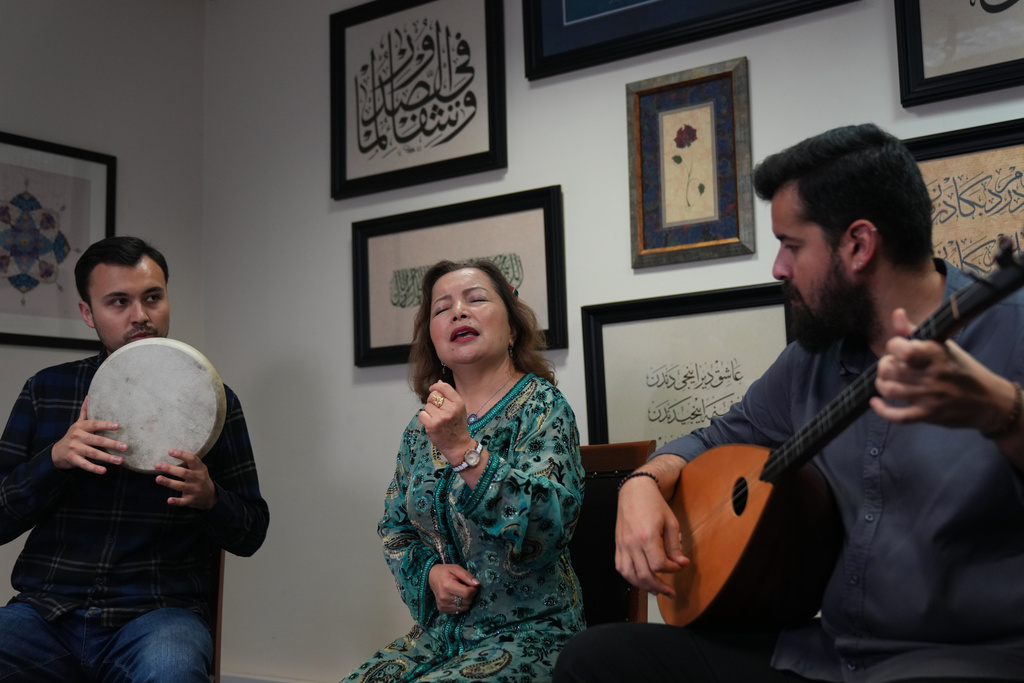 The London Uyghur Ensemble perform during an interview with The Associated Press in London, Wednesday, Oct. 8, 2025. (AP Photo/Joanna Chan)