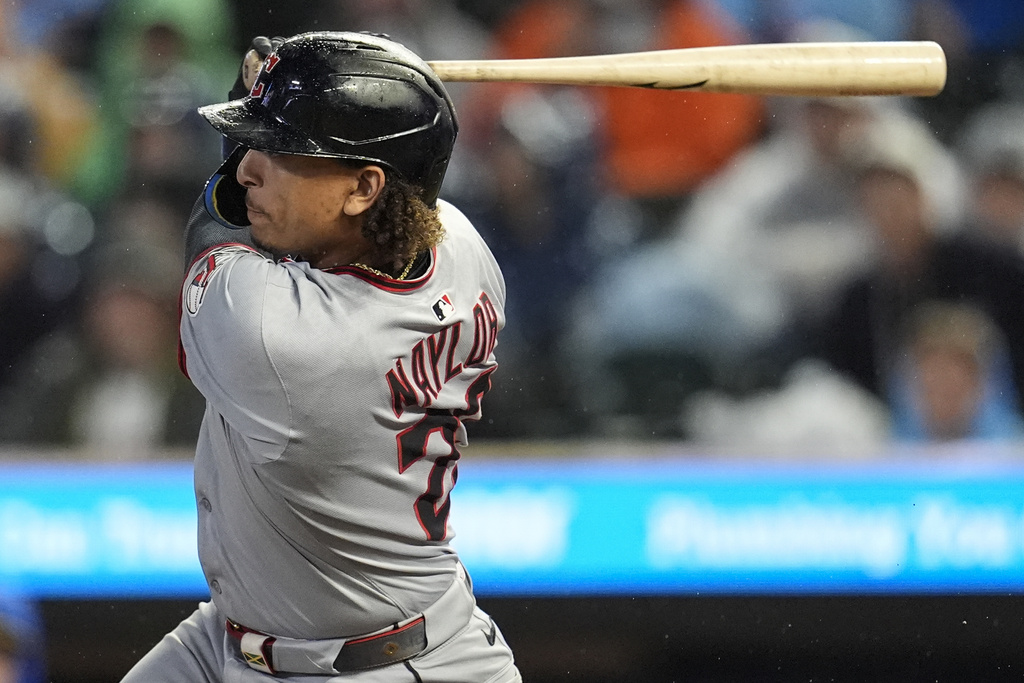 Cleveland Guardians' Bo Naylor (23) hits a two-RBI single against the Minnesota Twins in the first inning of a baseball game, Friday, Sept. 19, 2025, in Minneapolis. (AP Photo/Mike Stewart)