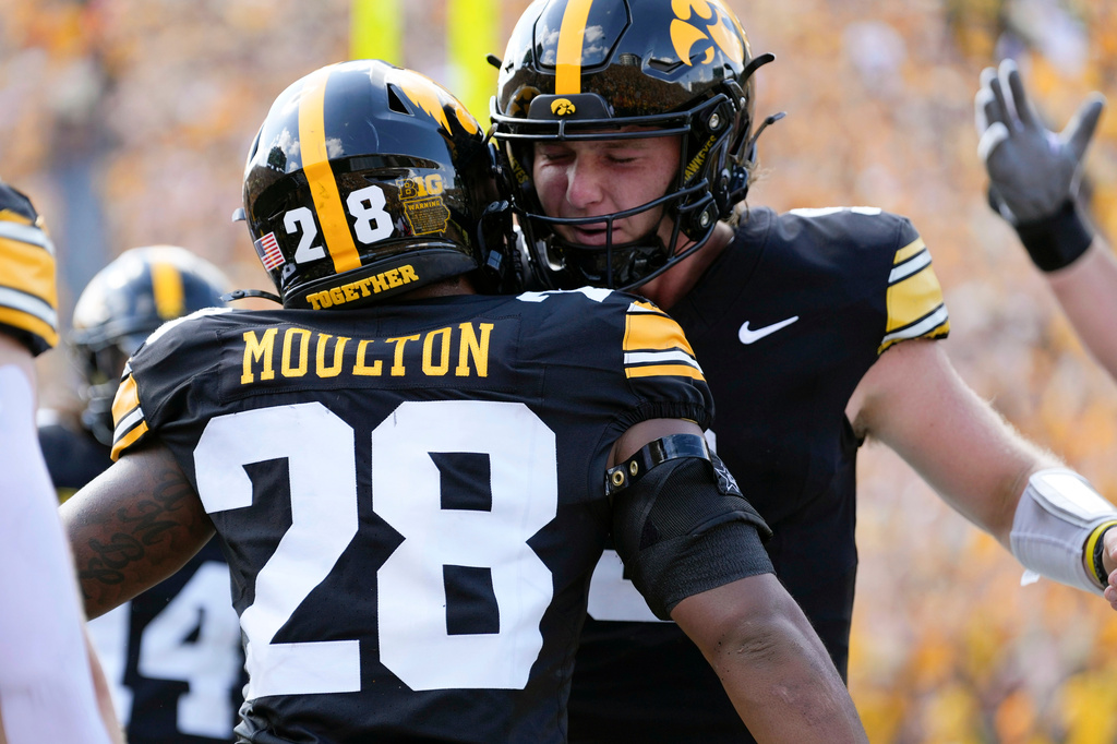 Iowa running back Kamari Moulton (28) celebrates with teammate quarterback Hank Brown after a touchdown run during the first half of an NCAA college football game against the Northern Illinois, Saturday, Sept. 5, 2026, in Iowa City, Iowa. (AP Photo/Charlie Neibergall)