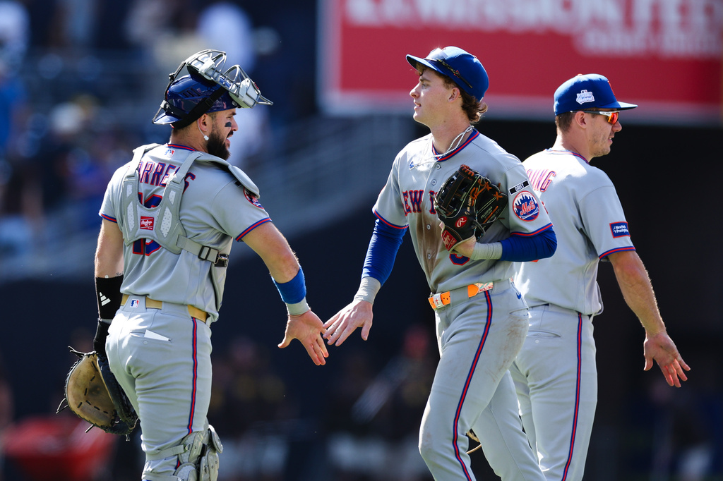 New York Mets' Carson Benge, center, celebrates with Luis Torrens, left, after their team defeated the San Diego Padres in a baseball game Sunday, June 7, 2026, in San Diego. (AP Photo/Derrick Tuskan)