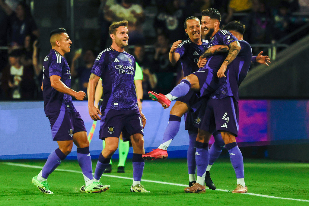 Orlando City SC forward Marco Pasalic, right, is lifted inn the air as he celebrates with team mates after scoring first goal against Inter Miami CF during the first half of an MLS soccer match, Sunday, March 1, 2026, in Orlando, Fla. (AP Photo/Kevin Kolczynski)