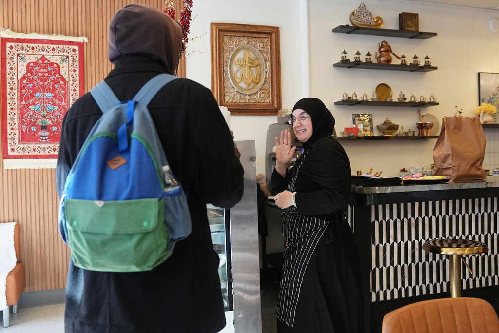 Emine Emanet waves goodbye to a guest at the Jersey Kebab restaurant, Thursday, Jan. 29, 2026, in Collingswood, N.J. (AP Photo/Matt Rourke)