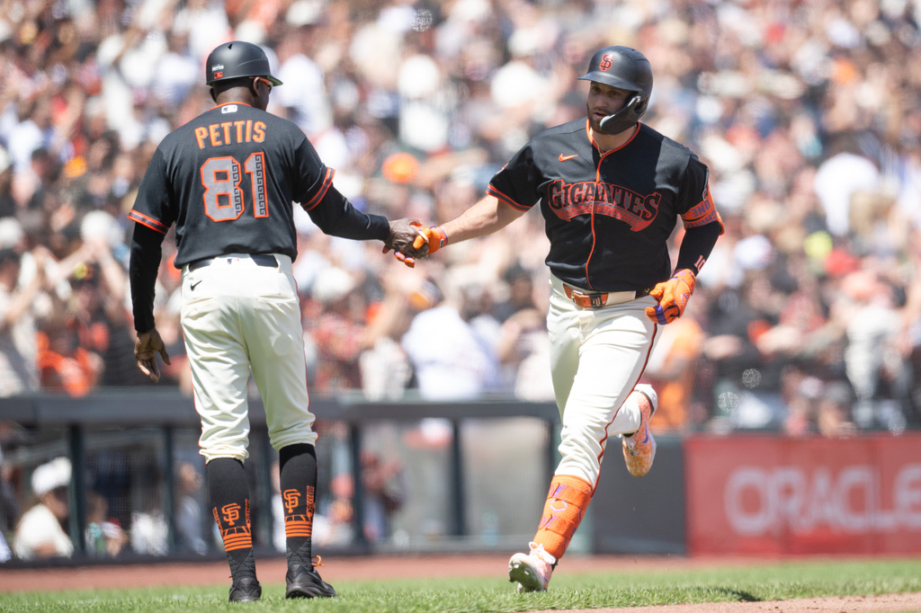 San Francisco Giants' Casey Schmitt (10), right, rounds the bases after hitting a three-run home run during the sixth inning of a baseball game against the Colorado Rockies Saturday, July 11, 2026, in San Francisco. (AP Photo/Thien-An Truong)