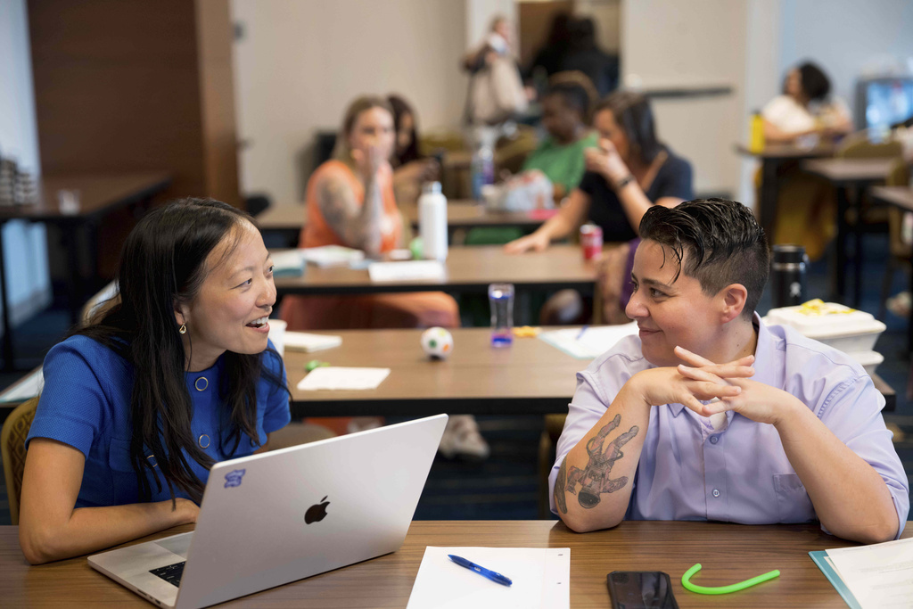 Deanna Jue Sutandi, left, who is running for the Decatur, Ga. city commission in the 2nd District, smiles while rehearsing a speech with Megan Wingfield, who is running for the U.S. House for 2nd District of Kentucky during the Emerge America Southern Regional Boot Camp, a camp designed for Democratic women to improve their political campaigns, in New Orleans, Aug. 10, 2025. (AP Photo/Matthew Hinton)