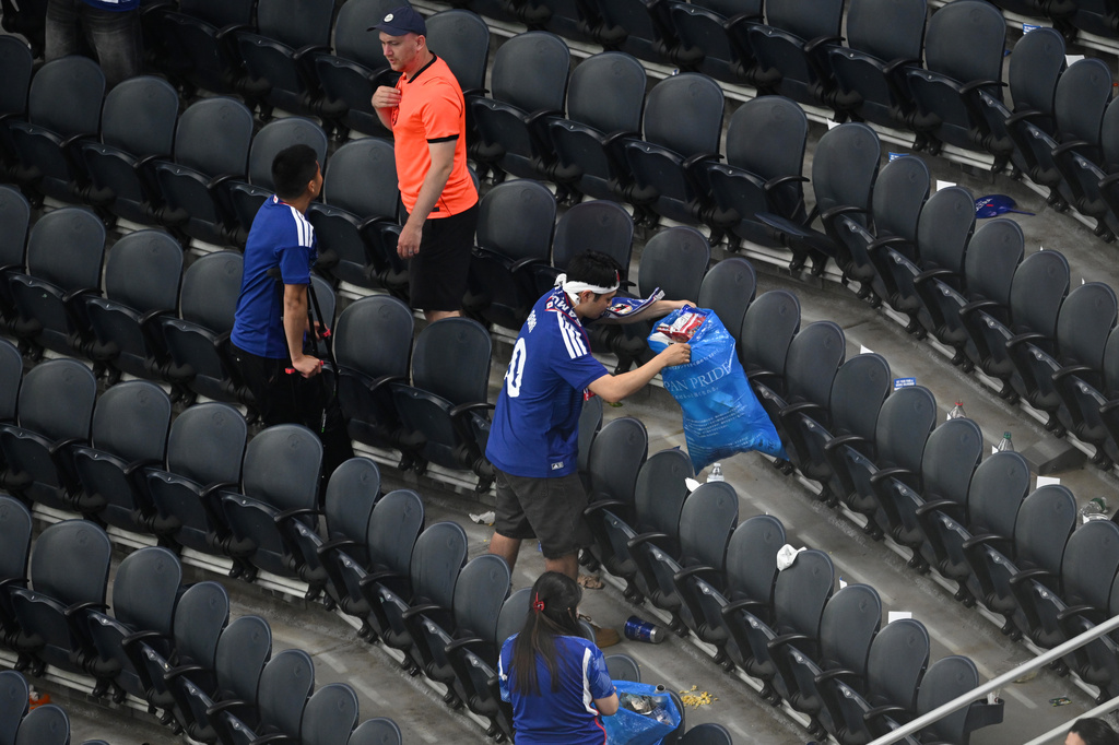 Japan fans clean up trash in the stadium following the World Cup Group F soccer match between the Netherlands and Japan in Arlington, Texas, near Dallas, Sunday, June 14, 2026. (AP Photo/Jessica Tobias)