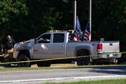 An investigator stands in front of a vehicle used by a man who allegedly rammed his vehicle Sunday into the side of The Church of Jesus Christ of Latter-day Saints in Grand Blanc Township, Mich., Tuesday, Sept. 30, 2025. (AP Photo/Ryan Sun) An investigator stands in front of a vehicle used by a man who allegedly rammed his vehicle Sunday into the side of The Church of Jesus Christ of Latter-day Saints in Grand Blanc Township, Mich., Tuesday, Sept. 30, 2025. (AP Photo/Ryan Sun)