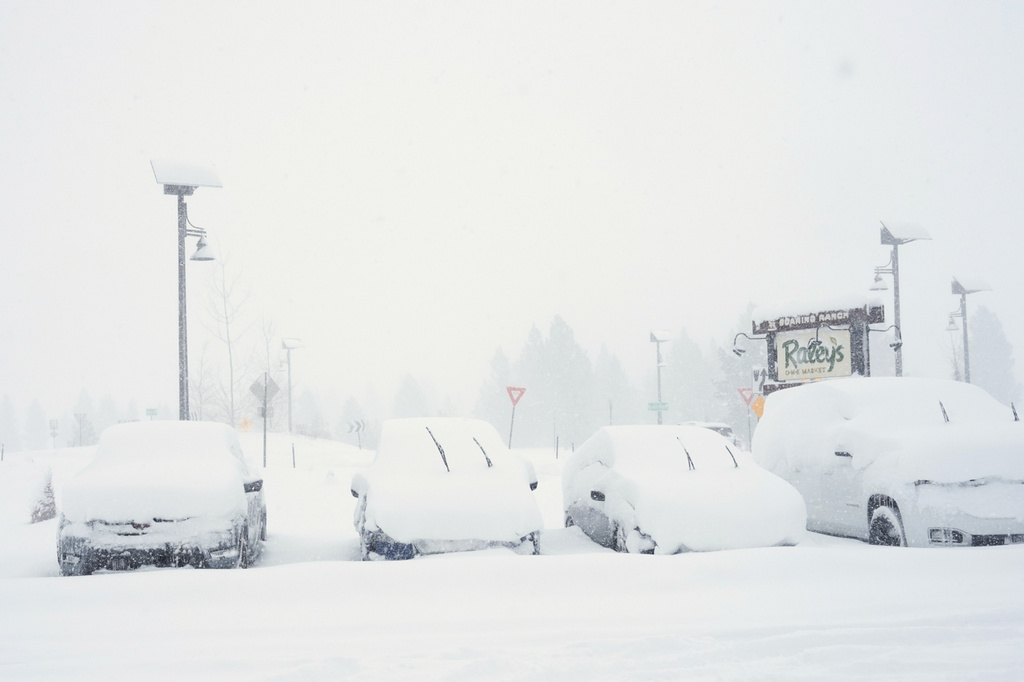 Cars are covered in snow during a snow storm on Tuesday, Feb. 17, 2026 in Truckee Calif. (AP Photos/Brooke Hess-Homeier)