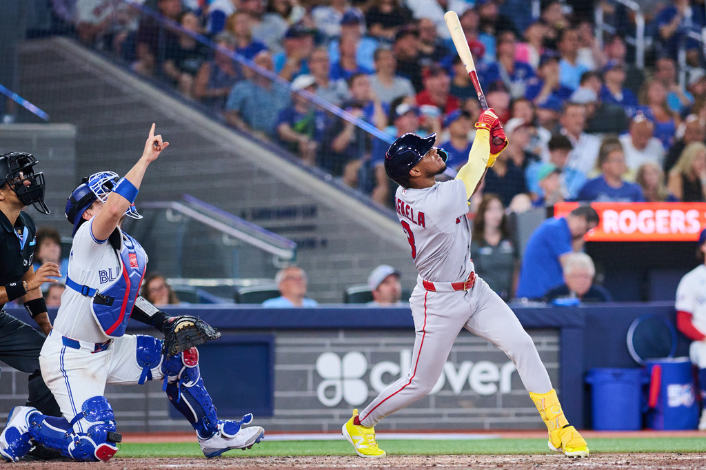 Boston Red Sox's Ceddanne Rafaela, right, flies into a sacrifice double play that was reviewed with a time play allowing Anthony Seigler (not shown) to score against the Toronto Blue Jays during the seventh inning of a baseball game in Toronto, Monday, Aug. 10, 2026. (Sammy Kogan/The Canadian Press via AP)