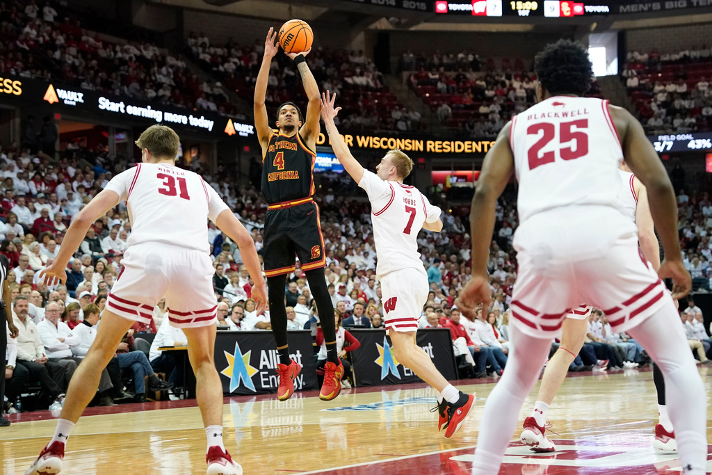 Southern California forward Chad Baker-Mazara (4) scores against Wisconsin guard Andrew Rohde (7) during the first half of an NCAA college basketball game Sunday, Jan. 25, 2026, in Madison, Wis. (AP Photo/Kayla Wolf)