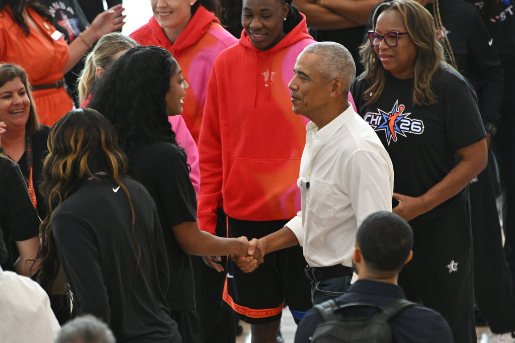 Former President Barack Obama greets WNBA All-Star Angel Reese, left, during a practice at the Obama Presidential Center in Chicago, Friday, July 24, 2026. (AP Photo/Paul Beaty)