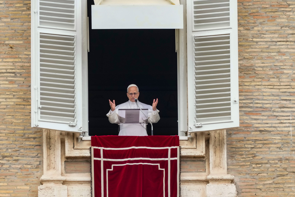 Pope Leo XIV appears at the window of his studio overlooking St. Peter's Square at the Vatican where Catholic faithful and pilgrims gathered for the traditional Sunday blessing at the end of the noon Angelus prayer, Sunday, March 15, 2026. (AP Photo/Andrew Medichini)