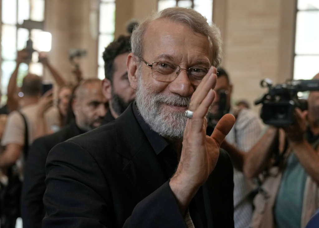 FILE - Iranian Secretary of Supreme National Security Council Ali Larijani, greets journalists upon his arrival to meet with the Lebanese parliament speaker Nabih Berri, in Beirut, Lebanon, Wednesday, Aug. 13, 2025. (AP Photo/Bilal Hussein, File)