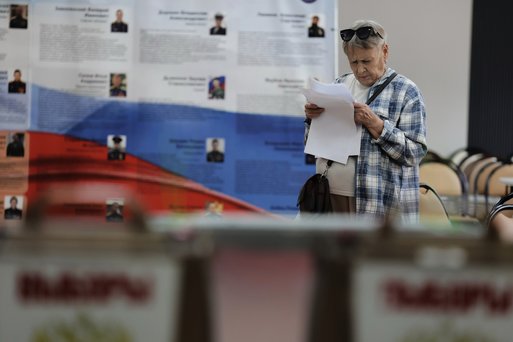 A voter holds her ballot prior to voting in the parliamentary election in Vladivostok, Russia, Friday, Sept. 18, 2026. (AP Photo)