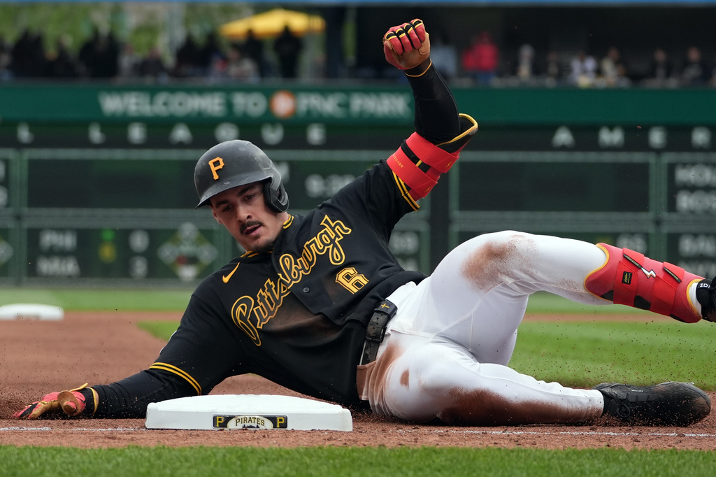 Pittsburgh Pirates' Konnor Griffin slides into third base on his triple off Cincinnati Reds pitcher Brock Burke in the fourth inning of a baseball game in Pittsburgh, Saturday, May 2, 2026. (AP Photo/Tom E. Puskar)