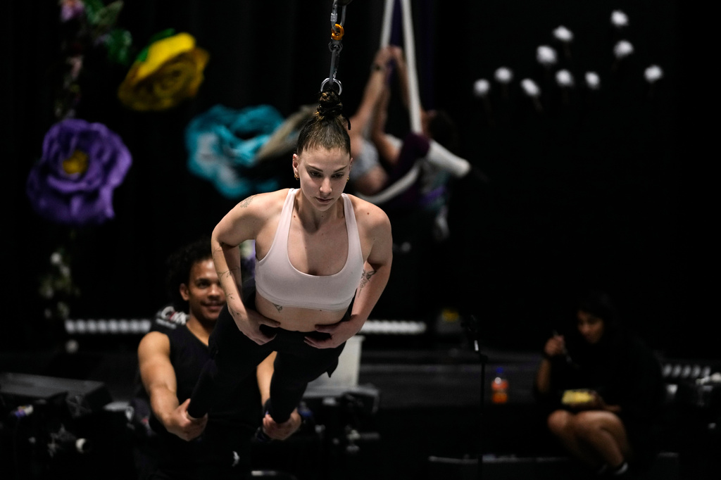 Performer Megan Nielsen, suspended by her hair, rehearses at The Cirk, a professional circus company in Johannesburg, Thursday, Aug. 27, 2026. (AP Photo/Themba Hadebe)