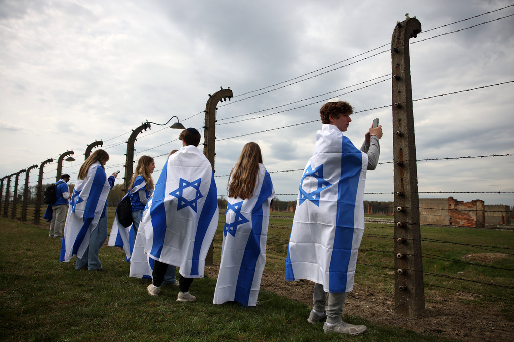 People take part in the annual "March of the Living" to commemorate the Holocaust, a yearly Holocaust remembrance march between the former death camps of Auschwitz and Birkenau, in Oswiecim, Poland, on Tuesday, April 14, 2026. (AP Photo/Beata Zawrzel)