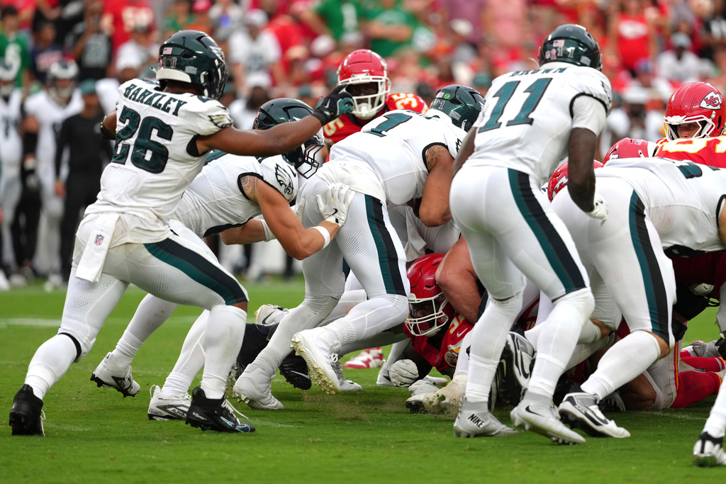 FILE - Philadelphia Eagles quarterback Jalen Hurts (1) gets a push from behind from Philadelphia Eagles tight end Grant Calcaterra (81) against the Kansas City Chiefs in the second half of an NFL football game, Sept. 14, 2025, in Kansas City, Mo. (AP Photo/Ed Zurga, File)