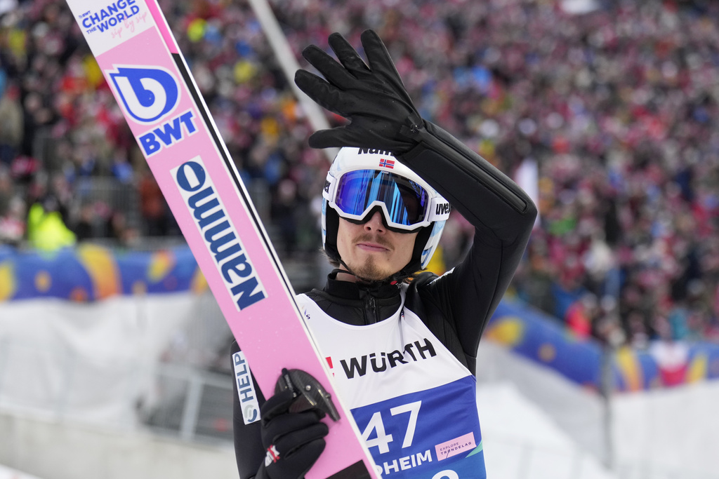 FILE - Johann Andre Forfang, of Norway, waves after his second round jump of the ski jumping men's large hill individual competition at the Nordic World Ski Championships in Trondheim, Norway, March 8, 2025. (AP Photo/Matthias Schrader, file)