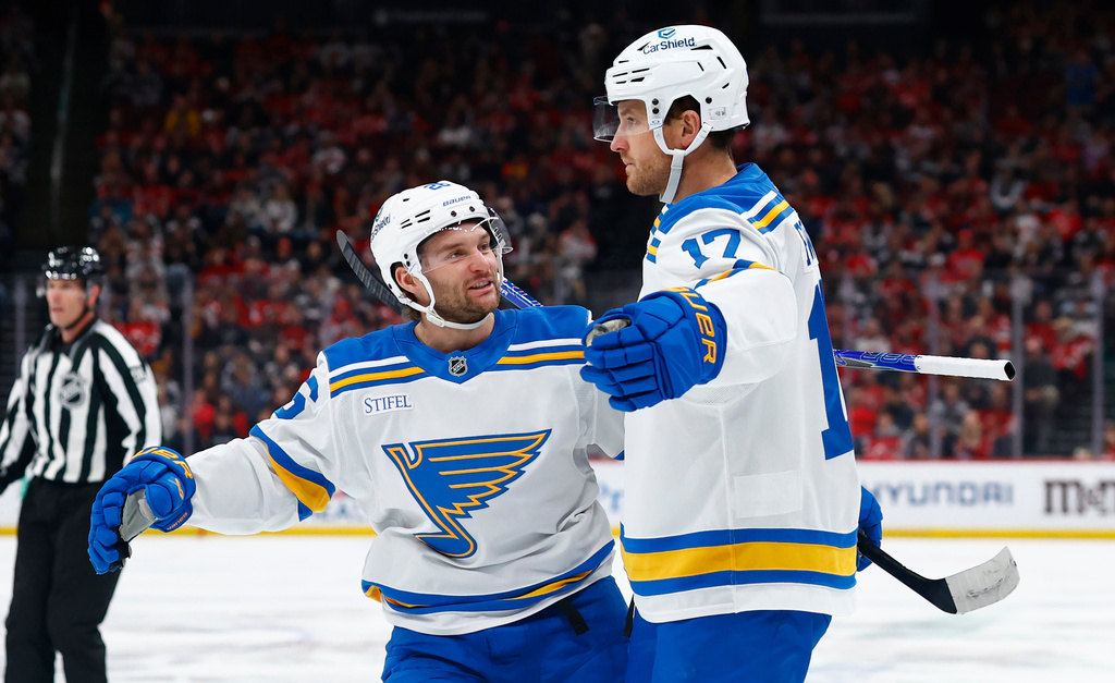 St. Louis Blues Nathan Walker, left, congratulates Cam Fowler (17) after his goal against the New Jersey Devils during the first period of an NHL hockey game, Wednesday, Nov. 26, 2025, in Newark, N.J. (AP Photo/Noah K. Murray)