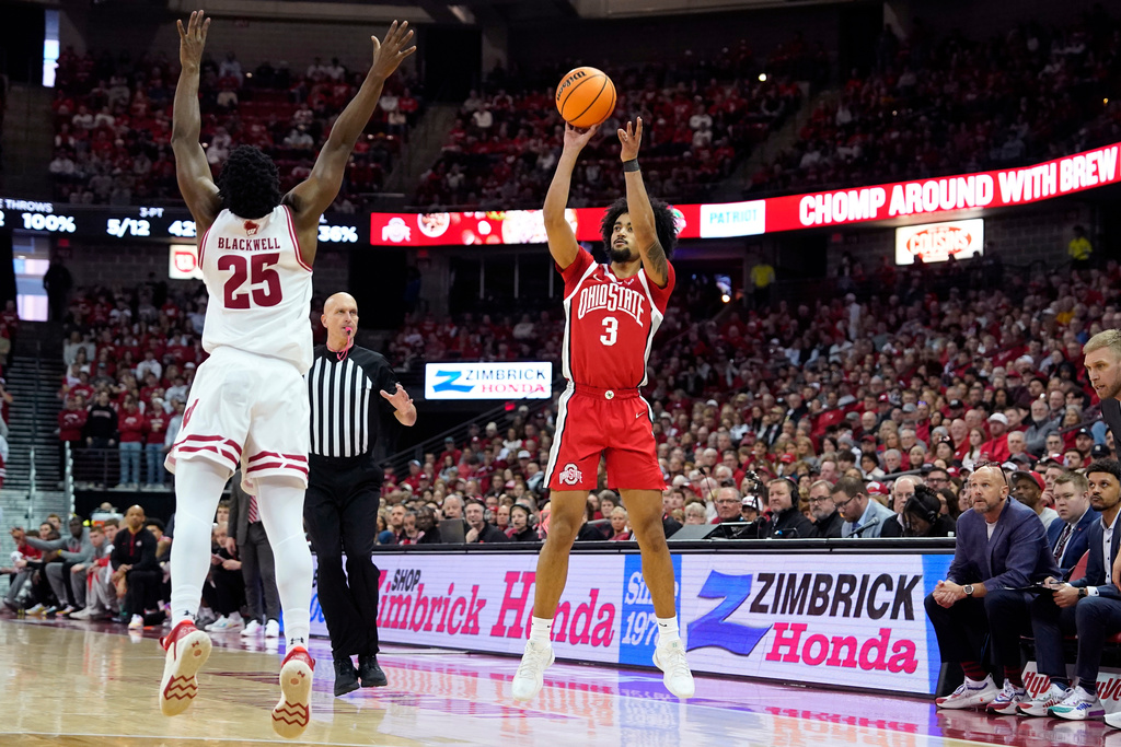 Ohio State guard Taison Chatman (3) scores a three-point basket against Wisconsin guard John Blackwell (25) during the first half of an NCAA college basketball game Saturday, Jan. 31, 2026, in Madison, Wis. (AP Photo/Kayla Wolf)