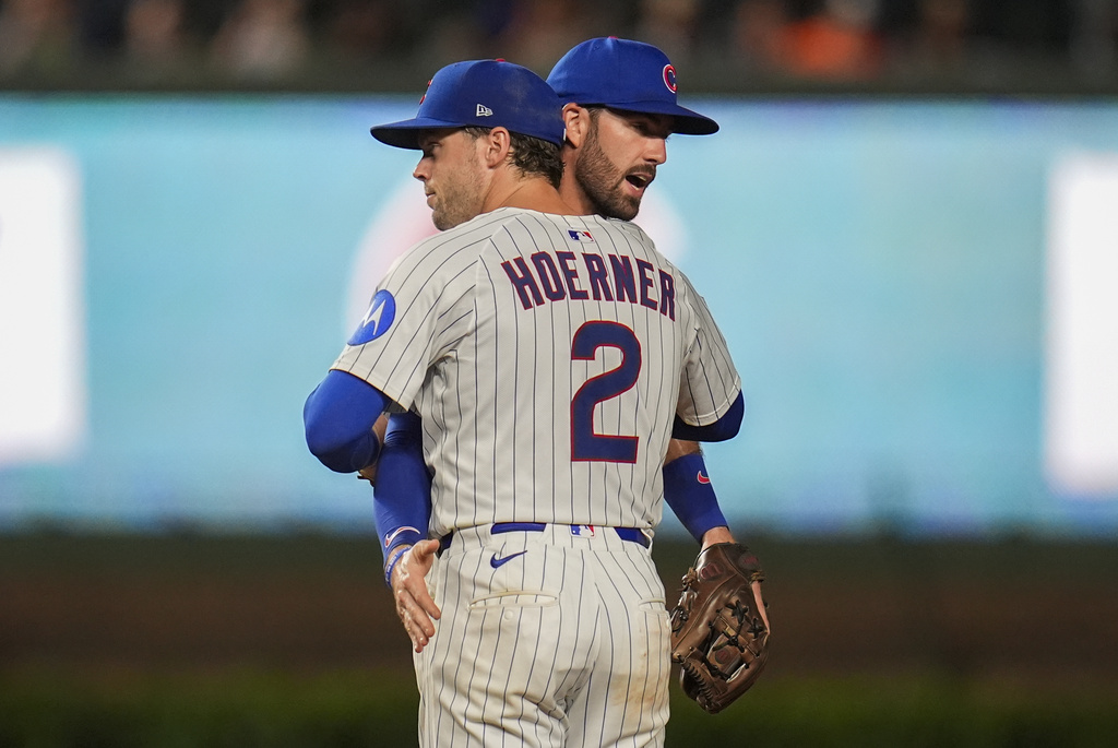 Chicago Cubs second baseman Nico Hoerner (2) and shortstop Dansby Swanson (7) celebrate their team's win over the Milwaukee Brewers in the second baseball game of a split doubleheader Tuesday, Aug. 19, 2025, in Chicago. (AP Photo/Erin Hooley)