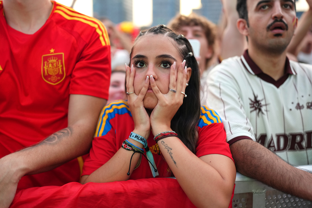 Spanish fans react while watching the World Cup final soccer match between Spain and Argentina on giant screens in Barcelona, Sunday, July 19, 2026. The match is being played in East Rutherford, N.J., near New York. (AP Photo/Joan Mateu Parra)