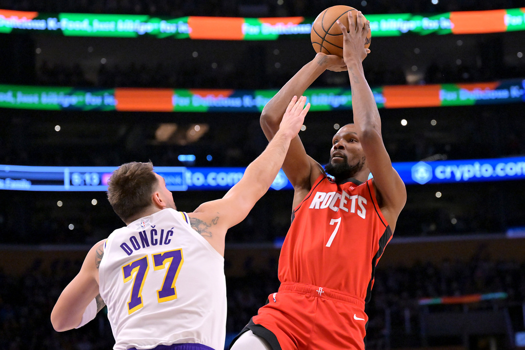 Los Angeles Lakers guard Luka Doncic (77) defends a shot by Houston Rockets forward Kevin Durant during the first half of an NBA basketball game, Thursday, Dec. 25, 2025, in Los Angeles. (AP Photo/Jayne Kamin-Oncea)