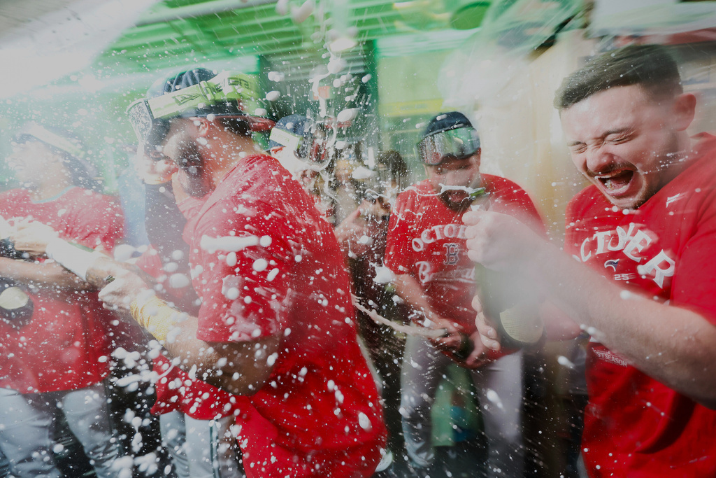 Boston Red Sox outfielder Wilyer Abreu (middle) celebrates with teammates after defeating the Detroit Tigers in a baseball game to advance to the post season, Friday, Sept. 26, 2025, in Boston. (AP Photo/Greg M. Cooper)