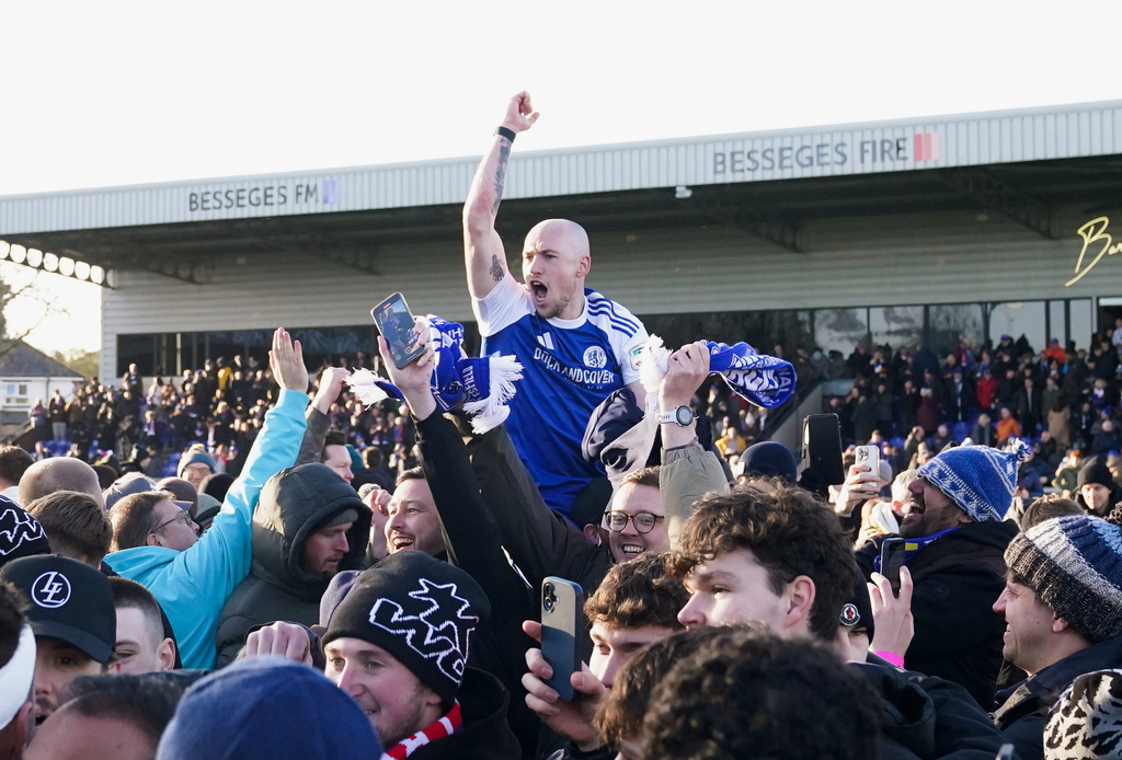 Macclesfield Town's Josh Kay celebrates with fans following the FA Cup third round soccer match between Macclesfield Town and Crystal Palace, at the Leasing.com Stadium, Macclesfield, England, Saturday, Jan. 10, 2026. (Martin Rickett/PA via AP)