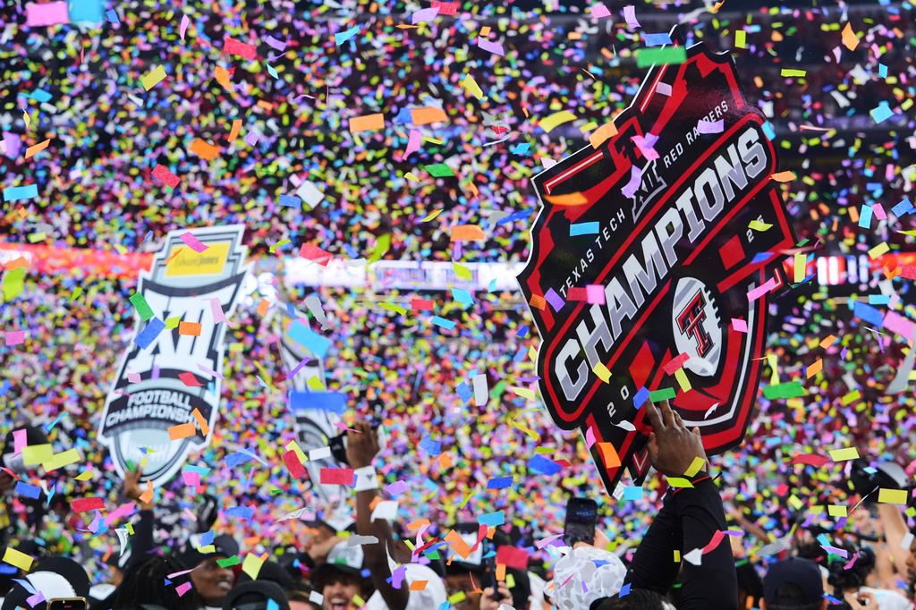 FILE - Texas Tech team and staff celebrate their win against BYU in the Big 12 Conference championship NCAA college football game Saturday, Dec. 6, 2025, in Arlington, Texas. (AP Photo/Julio Cortez,File)