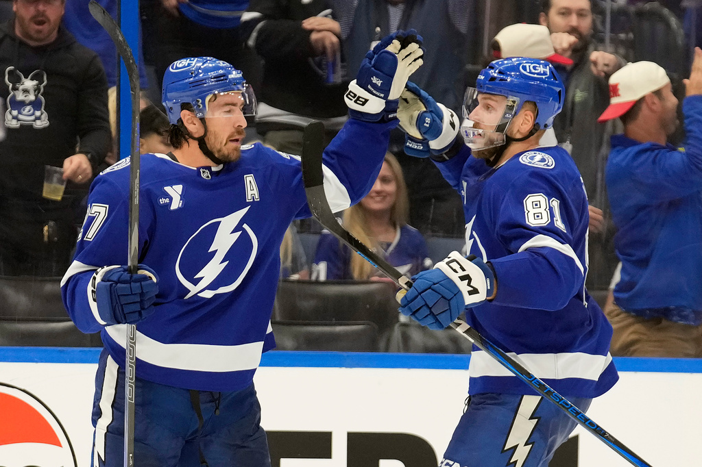 Tampa Bay Lightning defenseman Ryan McDonagh (27) celebrates his goal against the Chicago Blackhawks with defenseman Erik Cernak (81) during the second period of an NHL hockey game Thursday, Oct. 23, 2025, in Tampa, Fla. (AP Photo/Chris O'Meara)