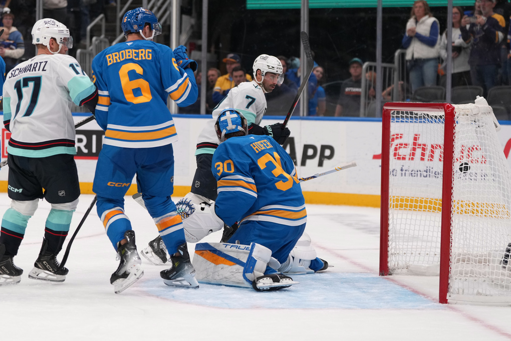 Seattle Kraken's Jordan Eberle (7) watches as a shot by teammate Chandler Stephenson finds the back of the net to score past St. Louis Blues goaltender Joel Hofer (30) during the third period of an NHL hockey game Saturday, Nov. 8, 2025, in St. Louis. (AP Photo/Jeff Roberson)
