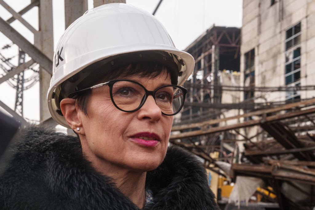 EU Commissioner for Enlargement Marta Kos looks at a production hall damaged after a recent Russian missile attack at DTEK's power plant in Ukraine, on Wednesday, Dec. 10, 2025. (AP Photo/Evgeniy Maloletka)