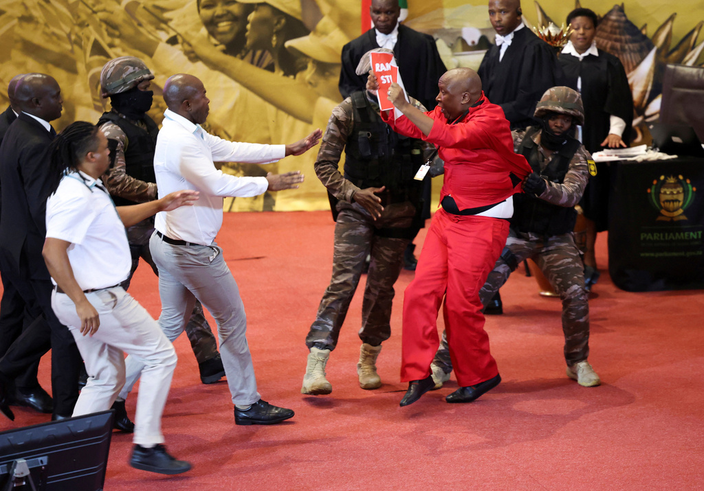 FILE - Opposition Economic Freedom Fighters party leader Julius Malema, center right, is removed by presidential task force as South African President Cyril Ramaphosa attempts to deliver his State of the Nation address to MP's in Cape Town, South Africa, on Feb. 9, 2023. (Esa Alexander/Pool Photo via AP, File)