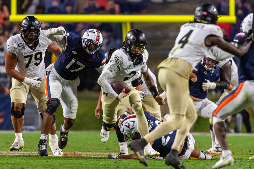 Wake Forest quarterback Robby Ashford (2) runs up the middle against Virginia during the second half of an NCAA college football game, Saturday, Oct. 4, 2025, in Charlottesville, Va. (AP Photo/Robert Simmons)