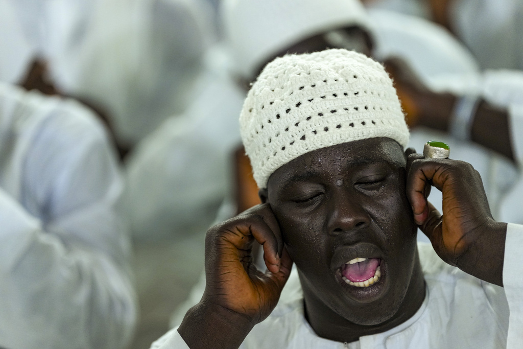 A man recites prayers as people mark Prophet Muhammad's birthday, known as Mawlid, in Dakar, Senegal, Friday, Sept. 5, 2025. (AP Photo/Misper Apawu)