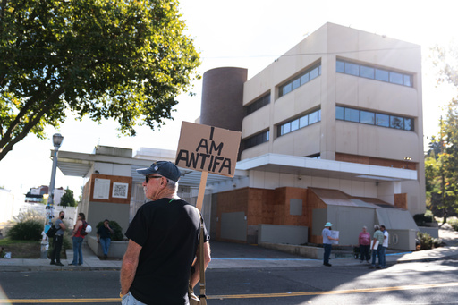 People protest outside a U.S. Immigration and Customs Enforcement facility on Sunday, Sept. 28, 2025, in Portland, Ore. (AP Photo/Jenny Kane) People protest outside a U.S. Immigration and Customs Enforcement facility on Sunday, Sept. 28, 2025, in Portland, Ore. (AP Photo/Jenny Kane)