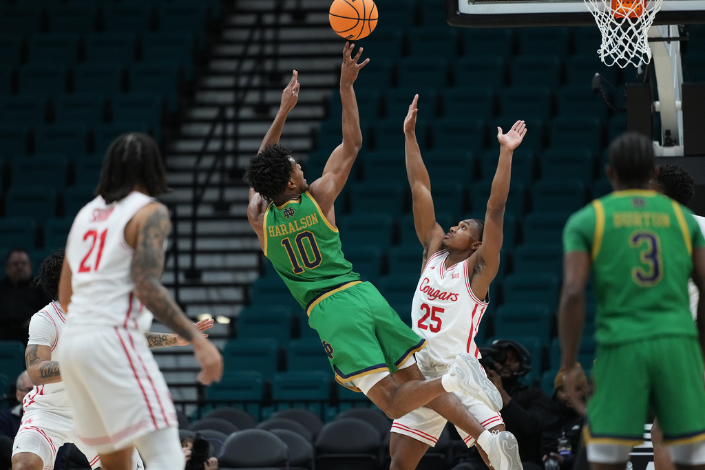 Notre Dame guard Jalen Haralson (10) shoots over Houston guard Mercy Miller (25) during the first half of an NCAA college basketball game in the Players Era tournament in Las Vegas, Wednesday, Nov. 26, 2025. (AP Photo/Eric Gay)