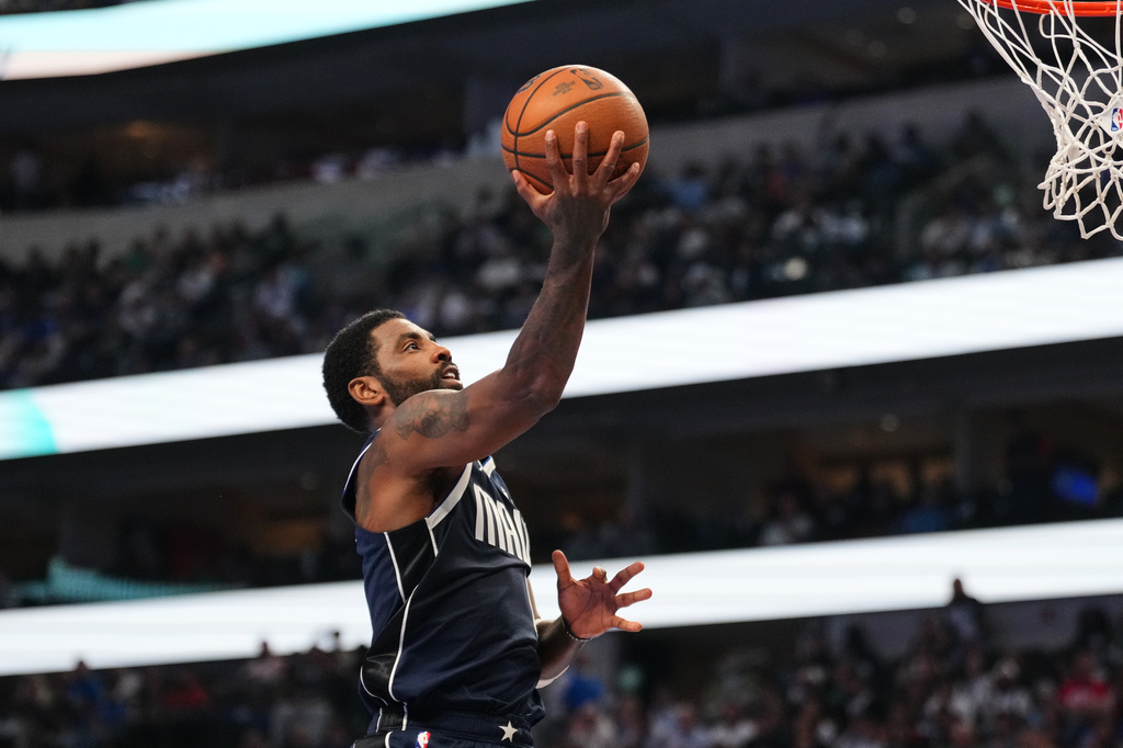 Dallas Mavericks guard Kyrie Irving leaps to the basket to take a shot during the first half of an NBA Cup basketball game against the Houston Rockets in Dallas, Friday, Oct. 30, 2026. (AP Photo/Tony Gutierrez)