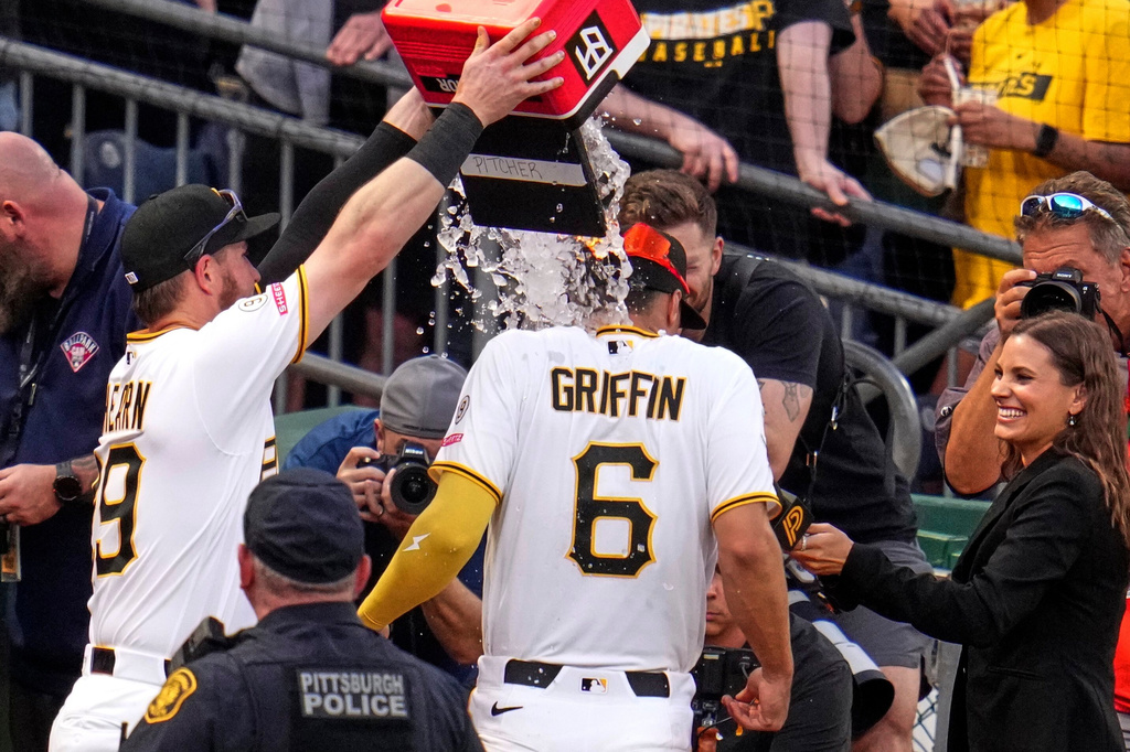 Pittsburgh Pirates' Ryan O'Hearn, left, dumps a cooler of ice on teammate Konnor Griffin (6) while Griffin is being interviewed following a baseball game against the Baltimore Orioles in Pittsburgh, Friday, April 3, 2026. (AP Photo/Gene J. Puskar)