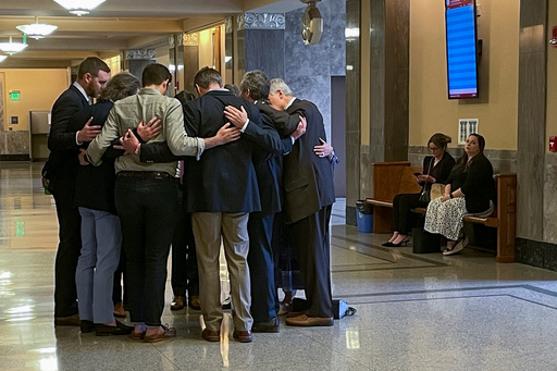 FILE - Covenant School parents and their attorneys huddle in prayer outside a courtroom before a hearing to decide whether documents and journals of a Nashville school shooter can be released to the public April 17, 2024, in Nashville, Tenn. (AP Photo/Travis Loller, File) FILE - Covenant School parents and their attorneys huddle in prayer outside a courtroom before a hearing to decide whether documents and journals of a Nashville school shooter can be released to the public April 17, 2024, in Nashville, Tenn. (AP Photo/Travis Loller, File)