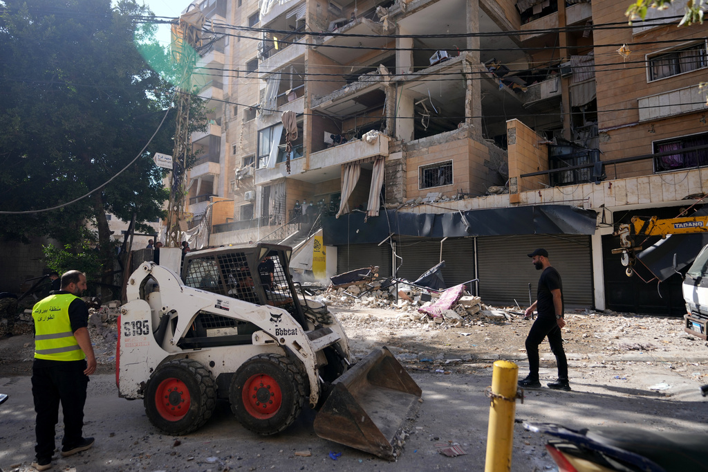 Municipality workers use a skid loader as they remove the rubble of destroyed apartments that where hit by an Israeli airstrike in Dahiyeh, Beirut's southern suburb, Lebanon, Sunday, June 7, 2026. (AP Photo/Hassan Ammar)