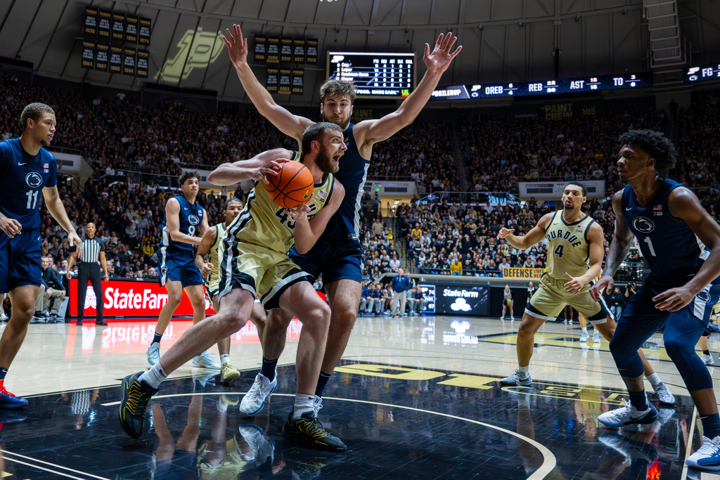 Purdue center Oscar Cluff (45) looks to shoot while being defended by Penn State forward Ivan Juric during the second half of an NCAA college basketball game, Saturday, Jan. 10, 2026, in West Lafayette, Ind. (AP Photo/Doug McSchooler)