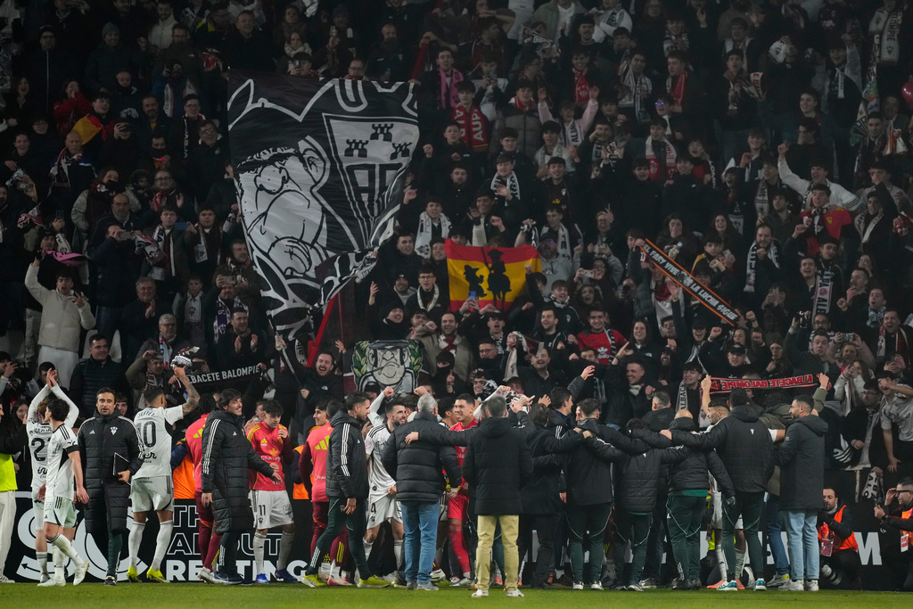 Albacete's players celebrate their team victory at the end the Copa del Rey round of 16 soccer match between Albacete and Real Madrid, in Albacete, Spain, Wednesday, Jan. 14, 2026. (AP Photo/Jose Breton)