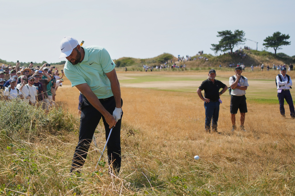 Scottie Scheffler of the United States plays out of the thick rough on the 17th hole during the first day of the British Open Golf championships at Royal Birkdale golf club, in Southport, England, Thursday, July 16, 2026. (AP Photo/Jon Super)
