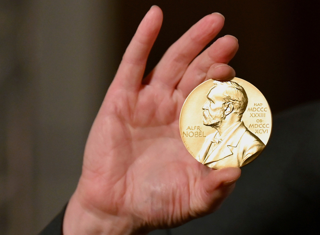 FILE - A Nobel medal is held up during a ceremony in New York, Dec. 8, 2020. (Angela Weiss/Pool Photo via AP, File)